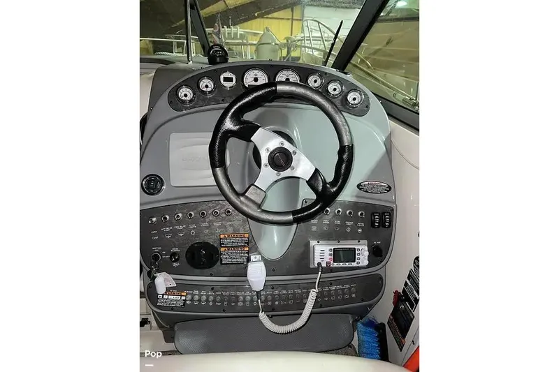 Slide: The Image of 2007 Maxum 2600 SE boat dashboard with steering wheel and control panel. - 7