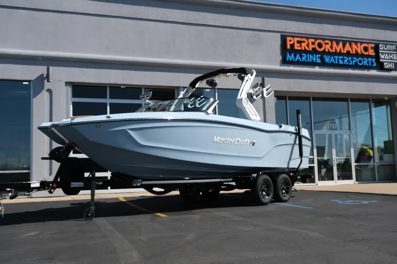 The Image of 2026 MasterCraft XT24 boat displayed at Performance Marine Watersports dealership. - 0