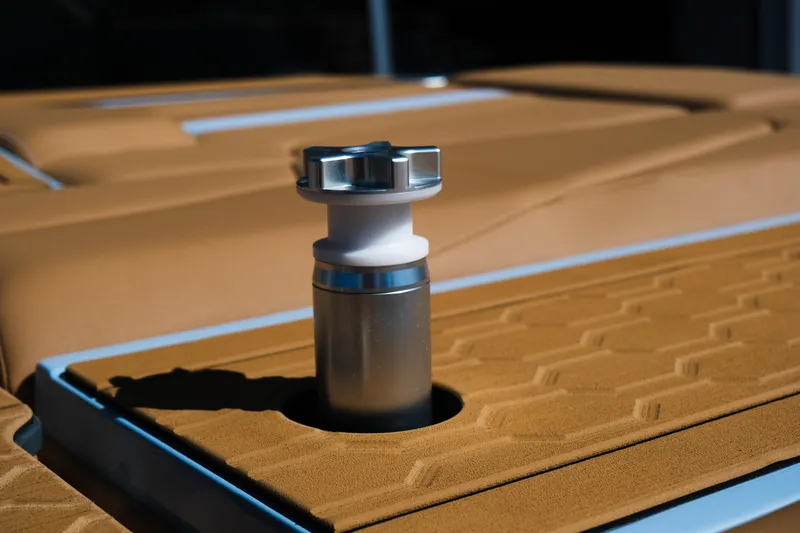 Slide: The Image of 2026 MasterCraft XT24 boat detail with tan upholstery and metal fixture. - 10