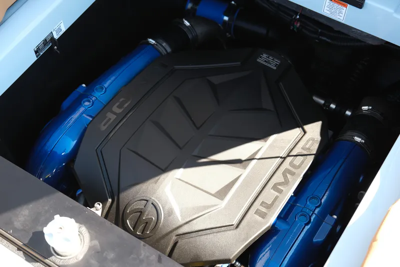 Slide: The Image of 2026 MasterCraft XT24 engine compartment with Ilmor cover and blue components. - 11