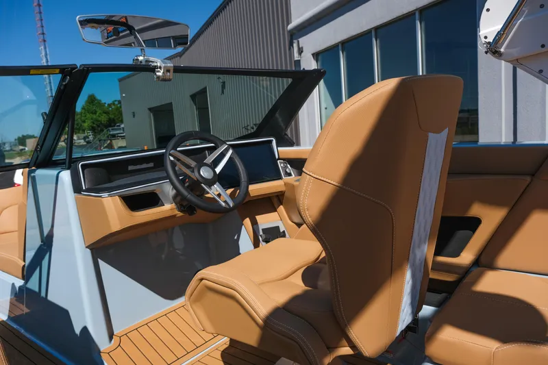 Slide: The Image of 2026 MasterCraft XT24 boat interior with tan leather seats and modern dashboard. - 20