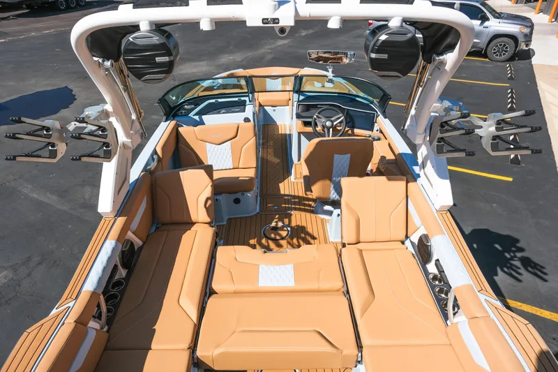 Slide: The Image of 2026 MasterCraft XT24 boat interior with tan seating and advanced audio system. - 27