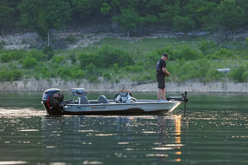 Slide: The Image of Manufacturer Provided Image: Man fishing on a 2026 Vexus AVX 1880 boat in a serene lake setting. - 4
