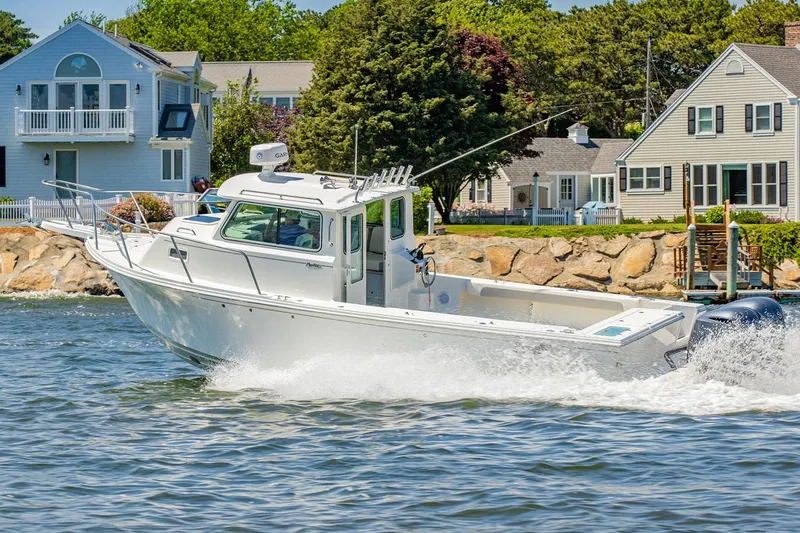 The Image of Manufacturer Provided Image: 2026 Parker 287 Explorer boat cruising near waterfront homes. - 0