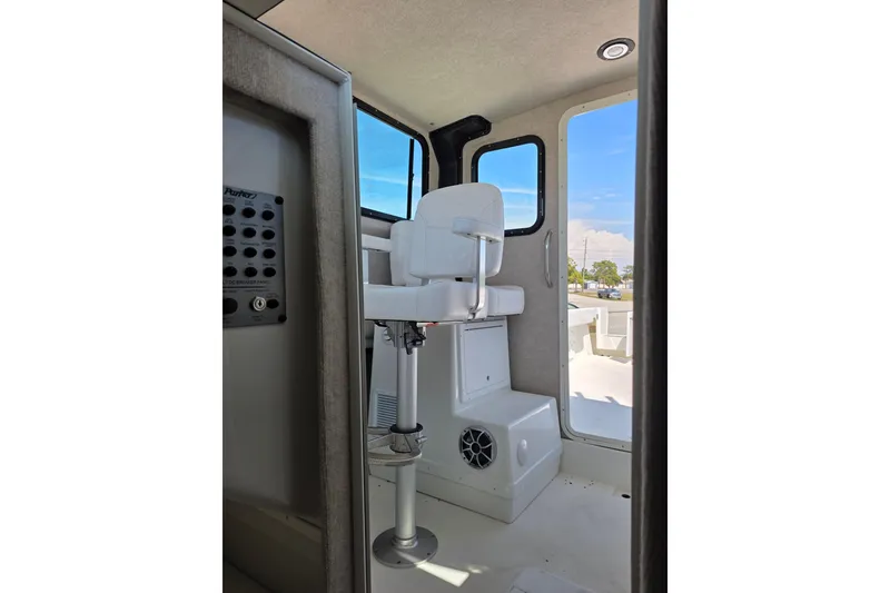 Slide: The Image of Interior view of 2026 Parker 287 Explorer boat with captain's chair and control panel. - 14