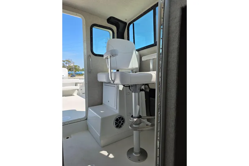Slide: The Image of Interior of 2026 Parker 287 Explorer boat with white captain's chair and windows. - 15
