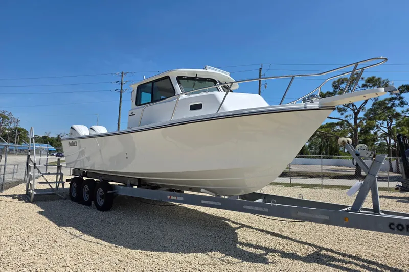 Slide: The Image of 2026 Parker 287 Explorer boat on trailer under clear blue sky. - 21