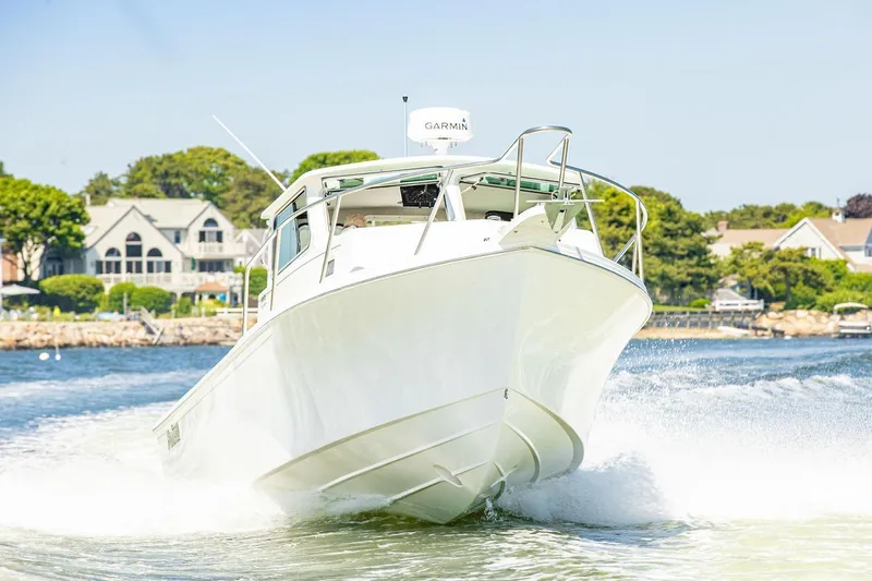 Slide: The Image of Manufacturer Provided Image: 2026 Parker 287 Explorer boat cruising on a sunny day near waterfront homes. - 3
