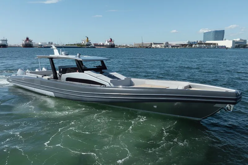 Slide: The Image of 2022 Novamarine BS 160 Outboard boat cruising in a harbor with cityscape background. - 11