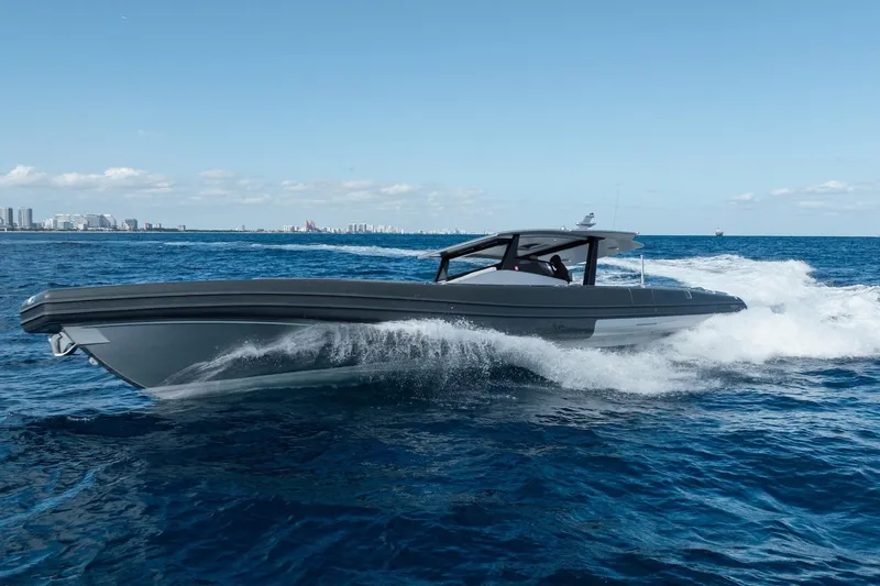 Slide: The Image of Novamarine BS 160 Outboard 2022 cruising on open sea with city skyline in background. - 12