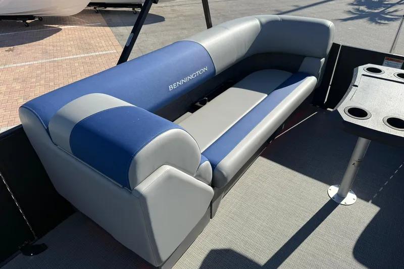 Slide: The Image of 2024 Bennington SSB-SPS boat seating with blue and gray upholstery, featuring cup holders. - 15