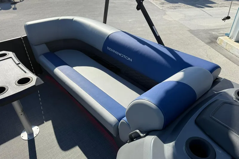 Slide: The Image of 2024 Bennington SSB-SPS boat seating with blue and gray upholstery, featuring cup holders. - 16