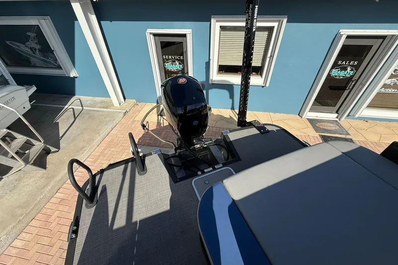 Slide: The Image of 2024 Bennington SSB-SPS boat at a dealership, featuring a sleek design and powerful motor. - 4