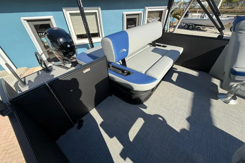 Slide: The Image of 2024 Bennington SSB-SPS boat interior with blue and gray seating, showcasing modern design. - 8