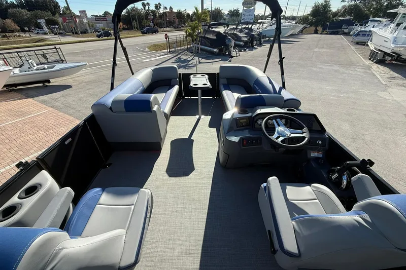 Slide: The Image of 2024 Bennington SSB-SPS pontoon boat interior with seating and steering console. - 9