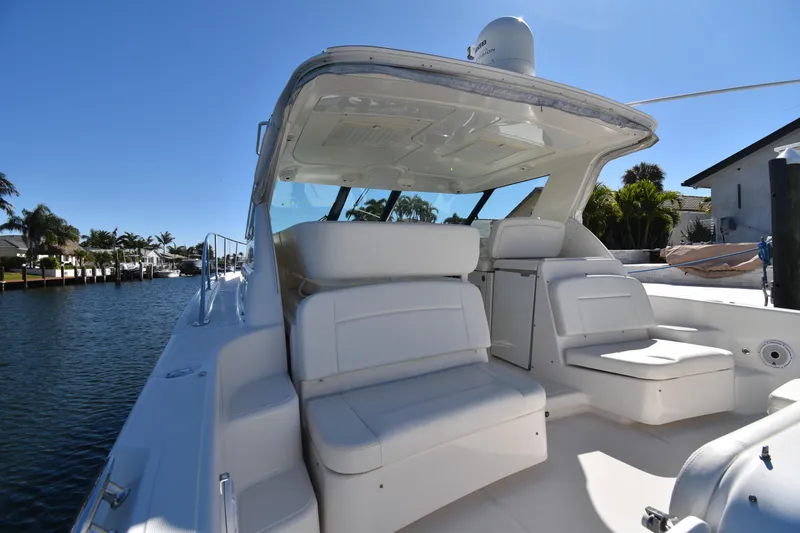 Slide: The Image of 2006 Tiara Yachts 3600 Open with spacious seating, docked by a serene waterfront. - 16