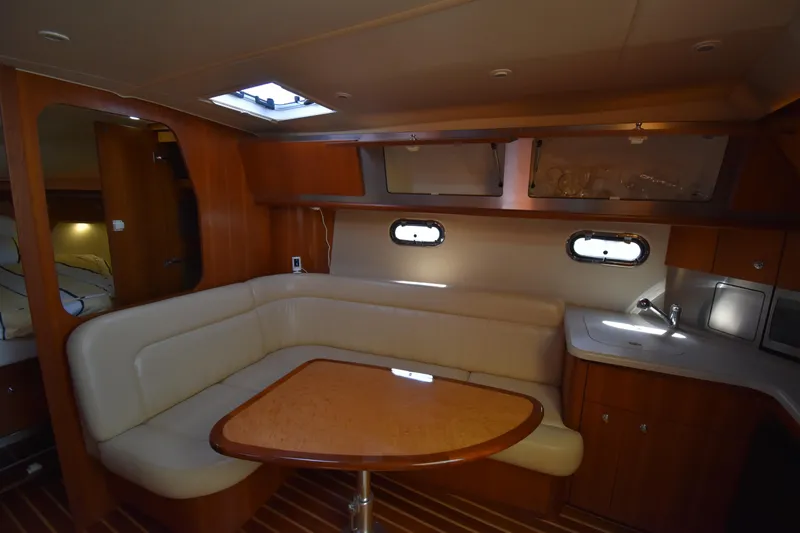 Slide: The Image of 2006 Tiara Yachts 3600 Open interior with cozy seating and wooden accents. - 19