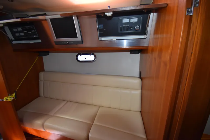 Slide: The Image of 2006 Tiara Yachts 3600 Open cabin interior with beige seating and control panels. - 20