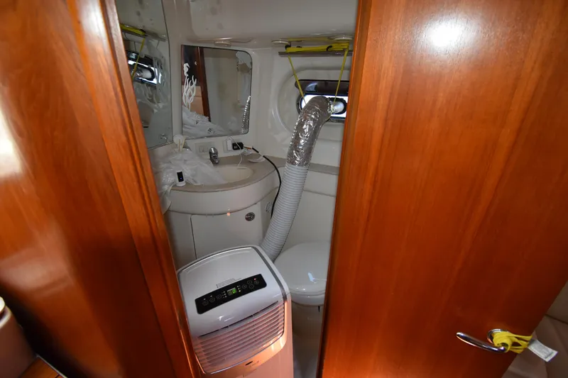 Slide: The Image of Bathroom interior of 2006 Tiara Yachts 3600 Open with wooden door and modern amenities. - 24