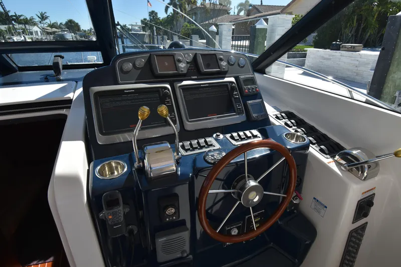 Slide: The Image of 2006 Tiara Yachts 3600 Open helm with navigation controls and steering wheel. - 8
