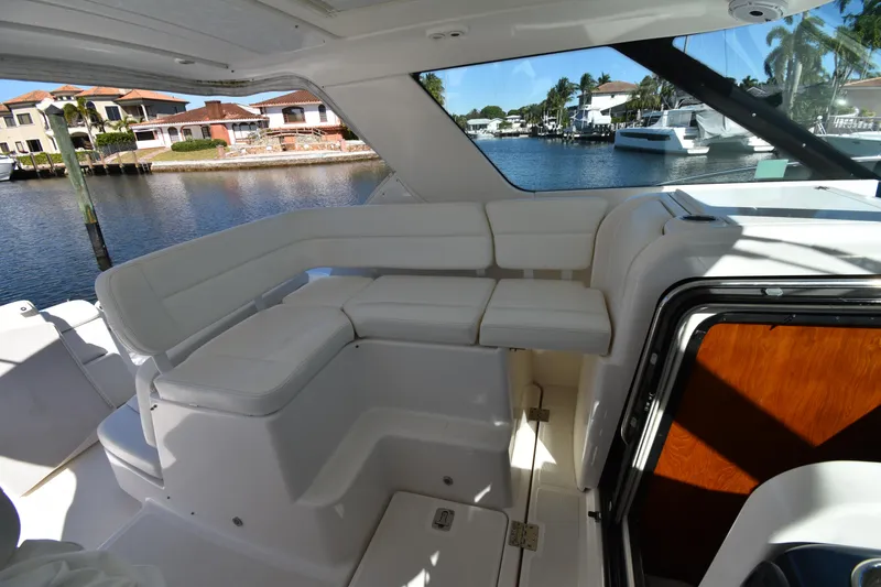 Slide: The Image of 2006 Tiara Yachts 3600 Open interior with white seating, dockside view. - 9
