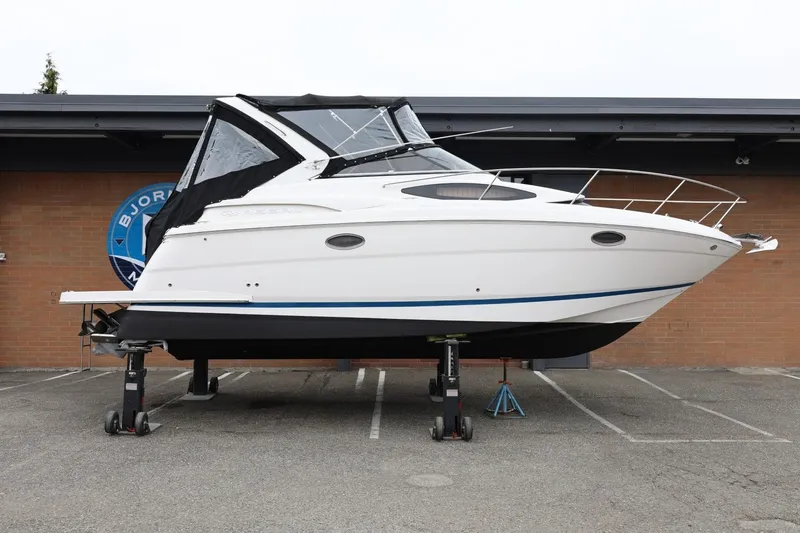 The Image of 2014 Regal 30 Express boat on stands, displayed outdoors. - 1