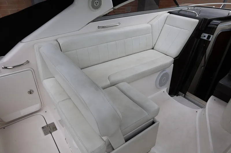 Slide: The Image of 2014 Regal 30 Express boat interior with white seating and speaker. - 10