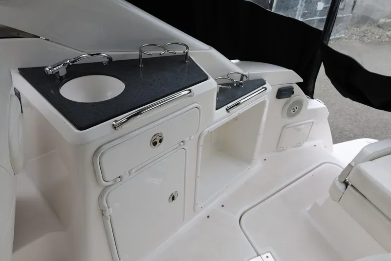 Slide: The Image of 2014 Regal 30 Express boat interior with sink and storage compartments. - 12
