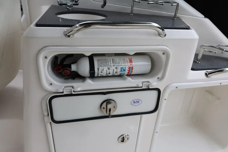 Slide: The Image of 2014 Regal 30 Express boat interior with fire extinguisher storage compartment. - 13