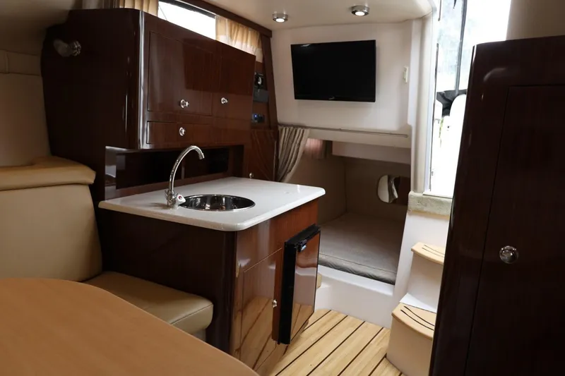 Slide: The Image of Luxurious interior of 2014 Regal 30 Express yacht with kitchenette and seating area. - 24