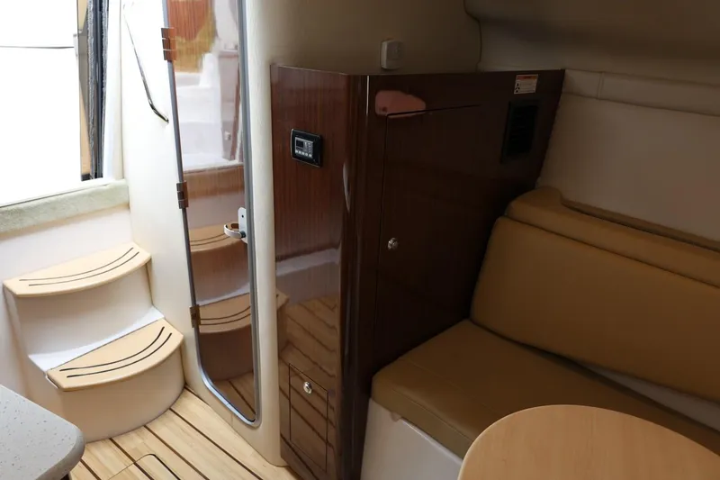 Slide: The Image of Interior of 2014 Regal 30 Express boat with seating and wooden cabinetry. - 25