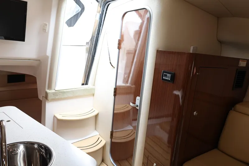 Slide: The Image of Interior of a 2014 Regal 30 Express boat, featuring a sleek cabin design. - 26
