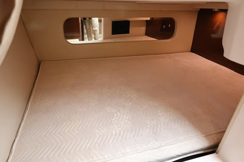 Slide: The Image of 2014 Regal 30 Express cabin interior with a comfortable mattress and mirror. - 28