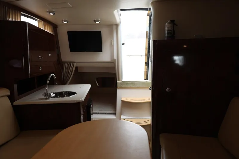Slide: The Image of Interior of 2014 Regal 30 Express boat with kitchenette and seating area. - 42