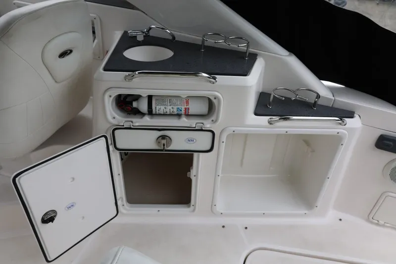 Slide: The Image of 2014 Regal 30 Express boat interior with storage compartments and fire extinguisher. - 48