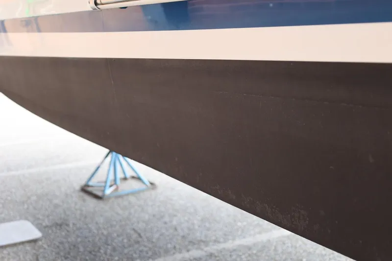 Slide: The Image of 2014 Regal 30 Express boat hull on a stand, showcasing sleek design. - 54