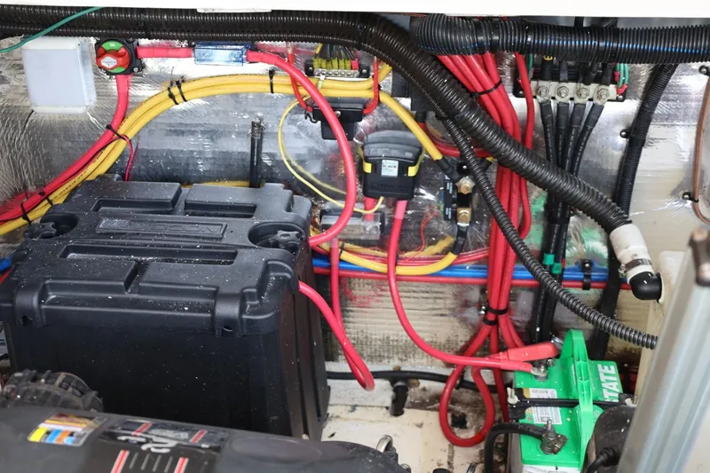 Slide: The Image of Engine compartment of 2014 Regal 30 Express with wiring and battery setup. - 61