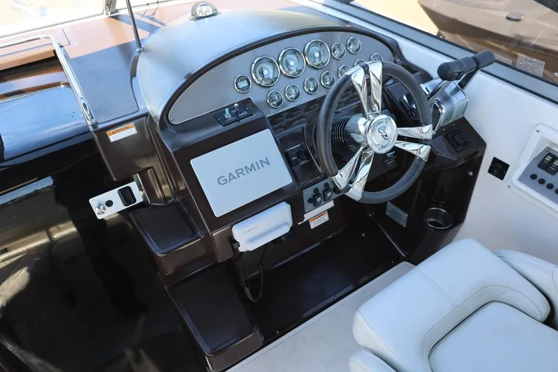 Slide: The Image of Cockpit of 2014 Regal 30 Express boat with Garmin navigation system and modern controls. - 65