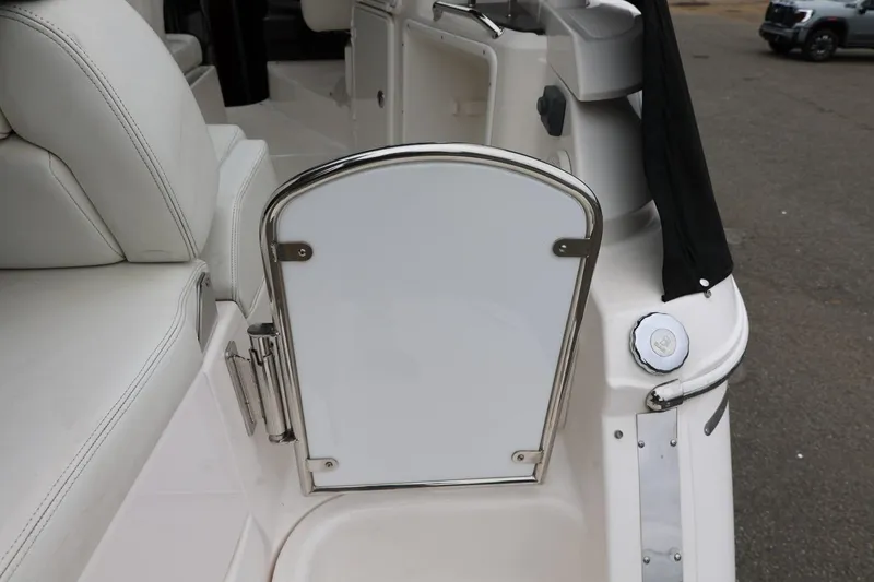 Slide: The Image of 2014 Regal 30 Express boat interior with white seating and stainless steel accents. - 8