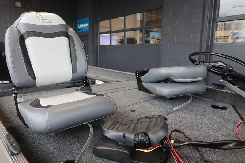 Slide: The Image of 2025 Lowe Skorpion 17 boat interior with gray seating and control panel. - 10
