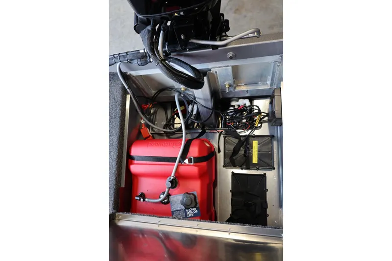 Slide: The Image of Interior view of 2025 Lowe Skorpion 17 boat showing engine and wiring components. - 13