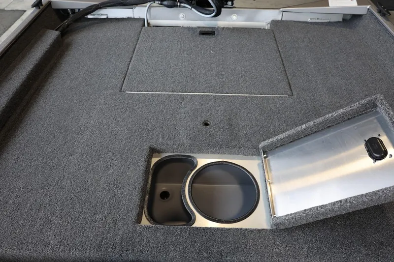 Slide: The Image of 2025 Lowe Skorpion 17 boat interior with storage compartment and carpeted deck. - 14