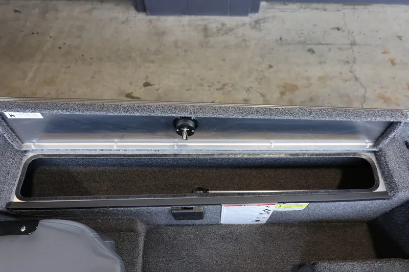 Slide: The Image of 2025 Lowe Skorpion 17 boat storage compartment with lock, featuring durable interior design. - 15
