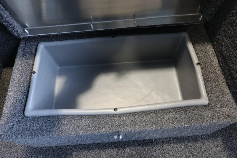 Slide: The Image of Storage compartment in 2025 Lowe Skorpion 17 boat, featuring a gray interior. - 17