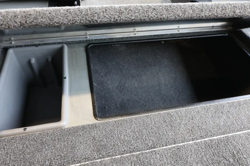 Slide: The Image of 2025 Lowe Skorpion 17 boat storage compartments with carpeted interior. - 20