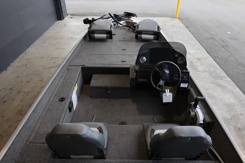 Slide: The Image of 2025 Lowe Skorpion 17 boat interior with steering console and seating. - 22