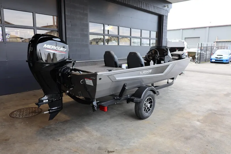 Slide: The Image of 2025 Lowe Skorpion 17 boat with Mercury engine on trailer in garage setting. - 25