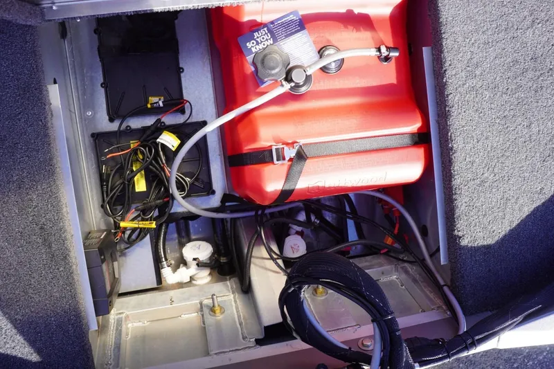 Slide: The Image of Interior view of a 2025 Lowe Skorpion 17 boat showing wiring and fuel tank. - 28