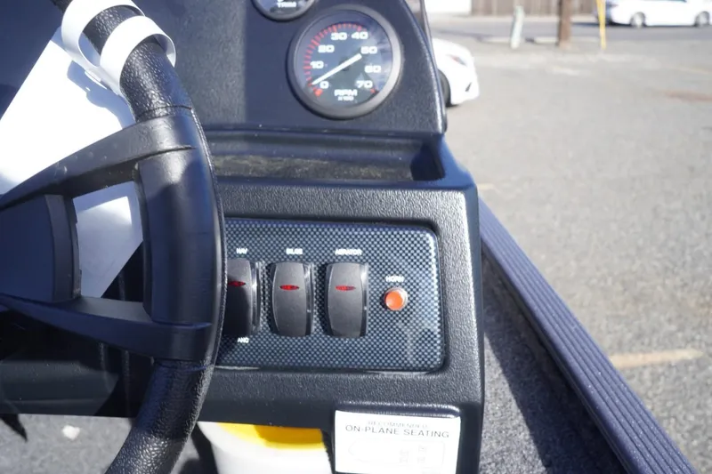 Slide: The Image of Dashboard of a 2025 Lowe Skorpion 17 boat with steering wheel and control switches. - 30