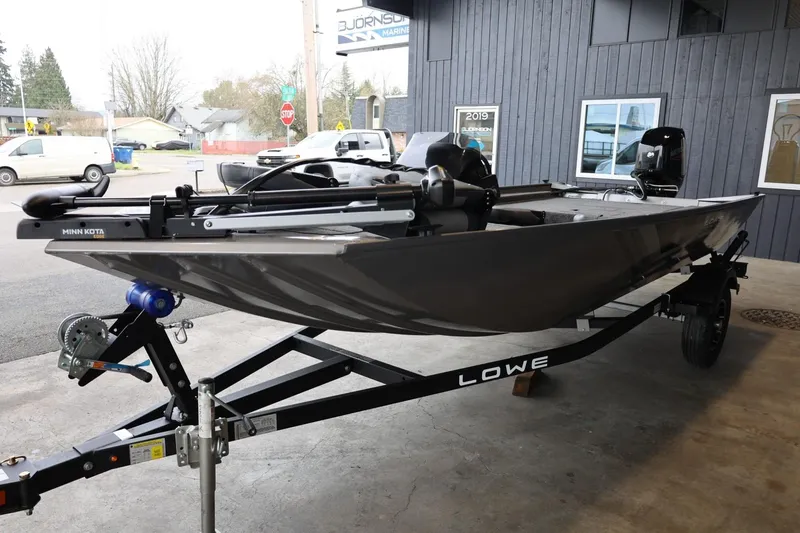 Slide: The Image of 2025 Lowe Skorpion 17 boat on trailer, parked outside a building. - 4